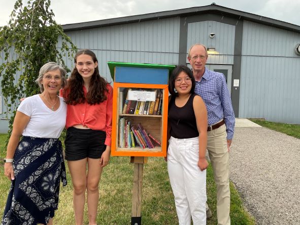 At the opening of the little library are Orangeville Public Library CEO Darla Fraser, Trinity Allen, Victoria Swanson, and Library Board Chair Bill Rea.