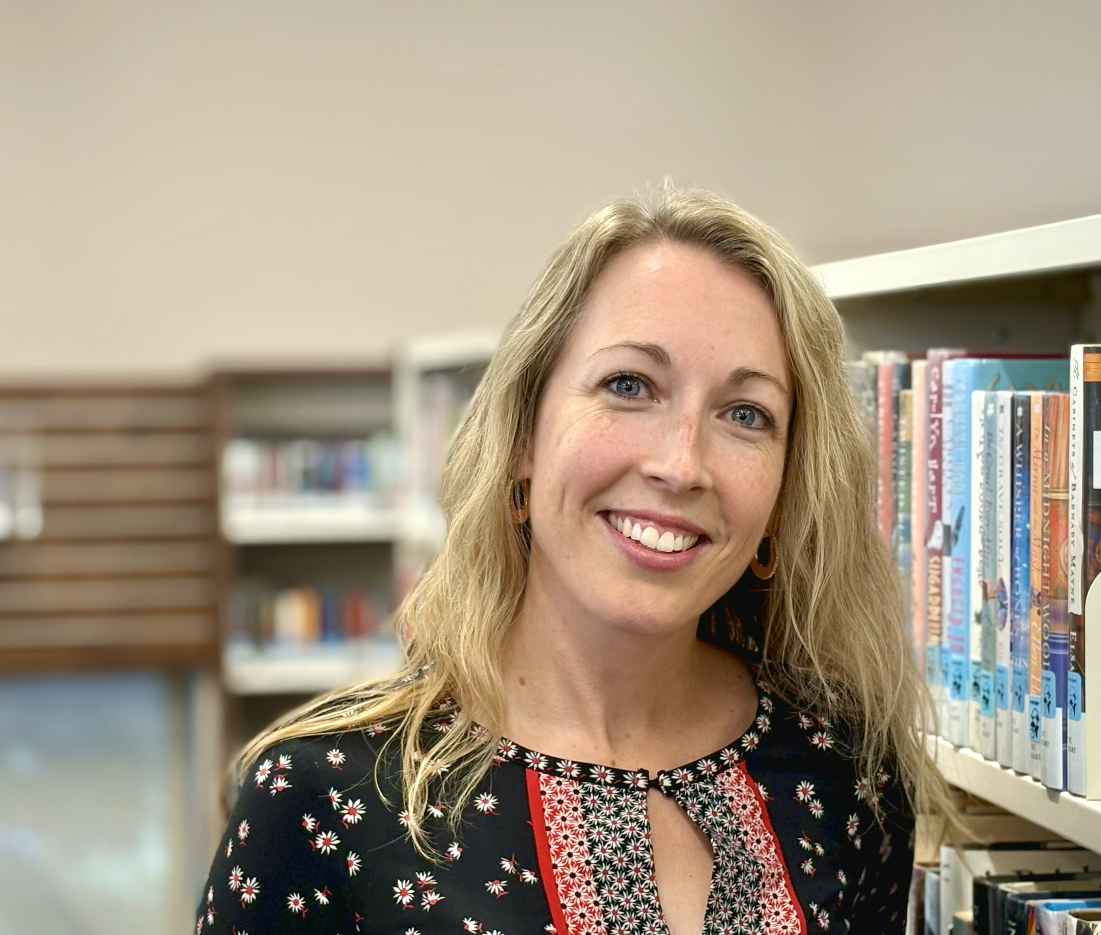 Shannon Mcgrady in front of shelf of books